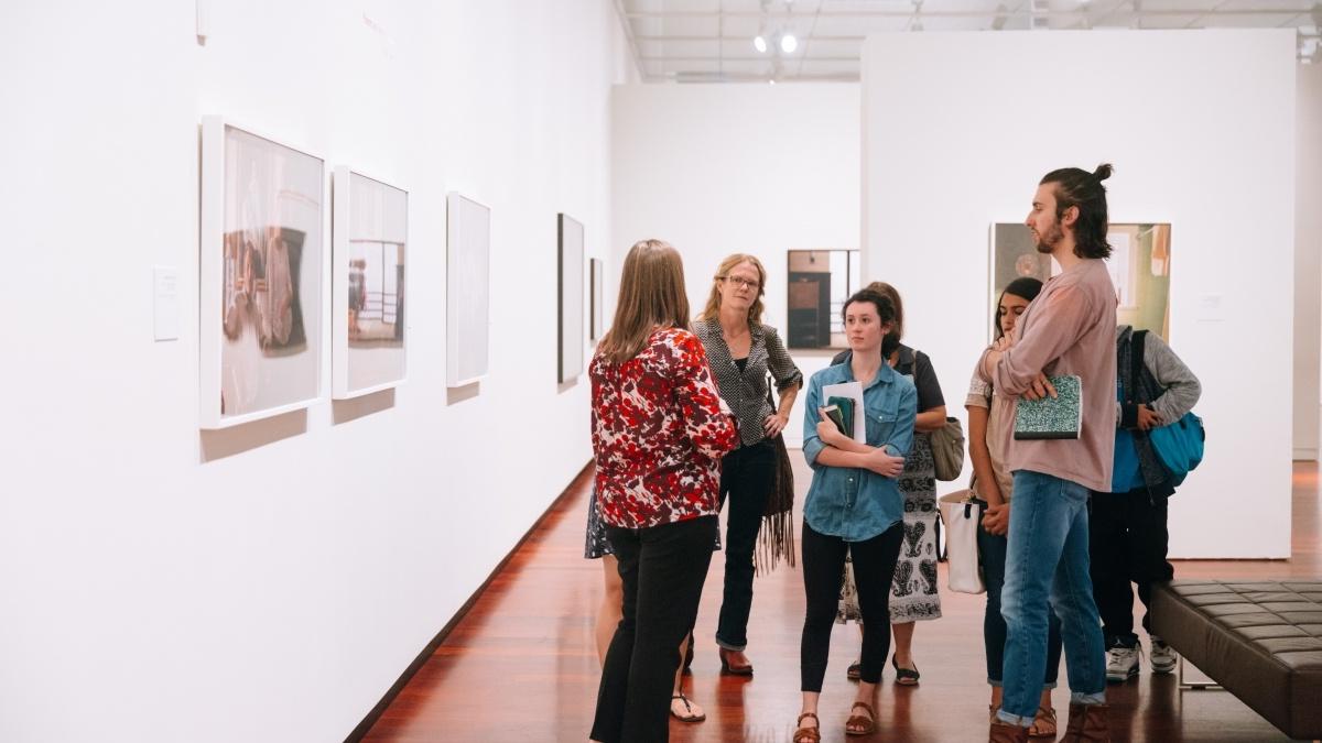 Group Gathered in Front of an Art Exhibit